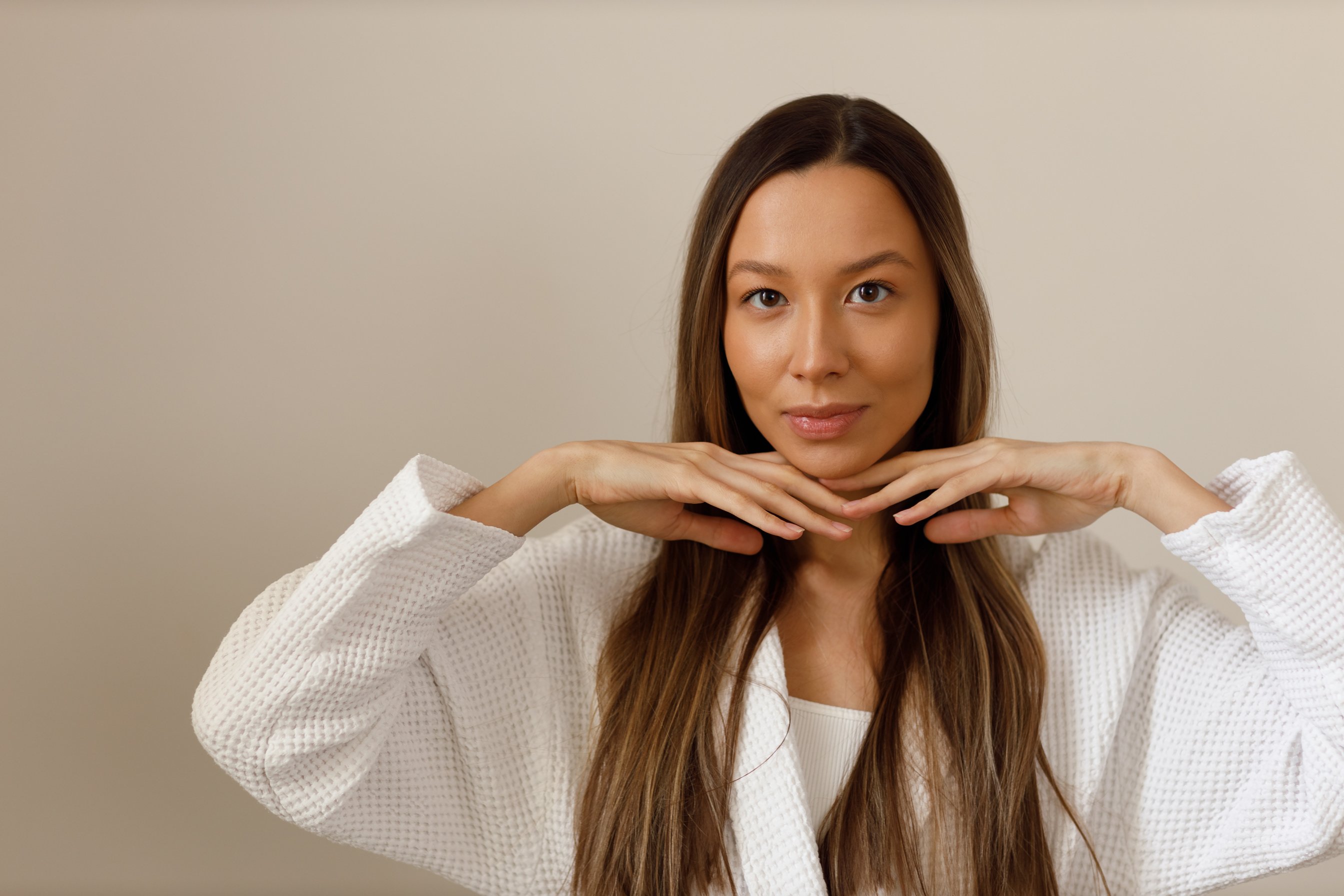 Young multiracial woman doing face building yoga and facial gymnastics self massage and rejuvenating exercises procedure